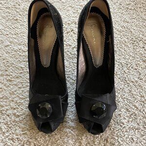 Black sequin peep-toe pumps with bow embellishment. Bourne size 38.
